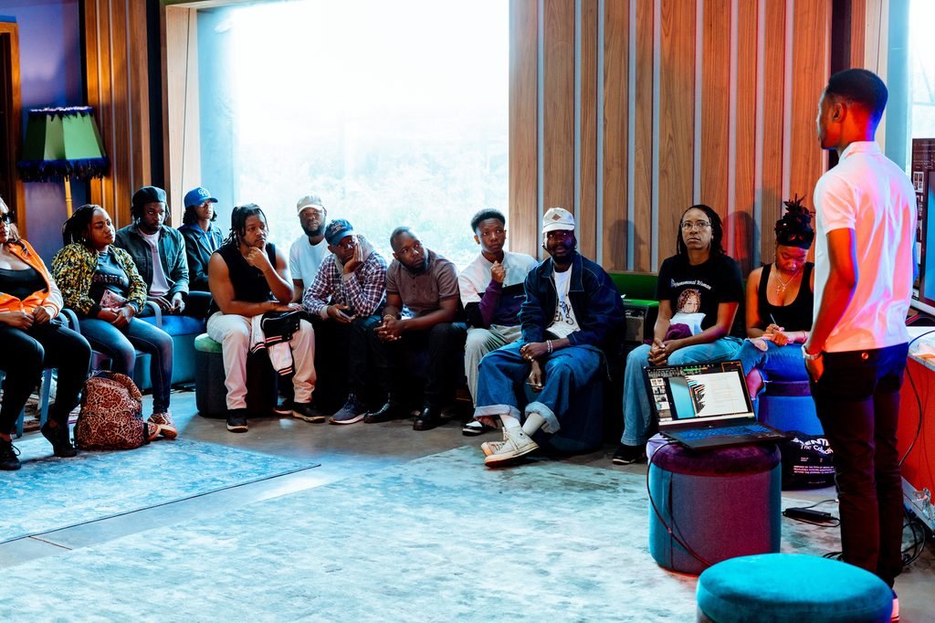 Eugene Ramirez Mapondera delivering a lecture to a group of creatives at Bridge North Studios, Harare, 2025